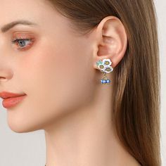 Transport yourself to a sun-drenched meadow with the enchanting Enamel Flower Blueberry Earrings. These blueberry earrings capture the essence of summer, featuring delicate enamel blooms in the vibrant hues of ripe blueberries . Accented with gleaming 18K gold-plated brass , each earring is a miniature work of art . More than just an accessory, these blueberry flower earrings are a whimsical escape. Imagine yourself strolling through a field of wildflowers, the sweet scent of berries filling the Elegant Blue Pierced Flower Earrings, Elegant Blue Flower Charm Earrings, Blue Clip-on Earrings Fine Jewelry, Formal Blue Flower Earrings, Elegant Blue Flower Drop Earrings, Blueberry Flower, Blueberry Earrings, Summer Magic, Field Of Wildflowers