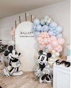 a room with balloons and mickey mouse decorations