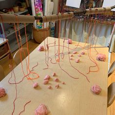 the table is covered with pink icing and orange string on it's sides