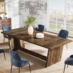 a wooden table with blue chairs around it