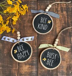 bee kind, be happy, busy bee painted on wood slices with yellow flowers in the background