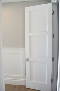 an empty room with white walls and wood flooring is pictured in this image from the doorway