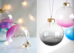 three different colored glass ornaments hanging from strings