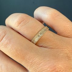 a woman's hand with a yellow diamond ring on top of her left hand