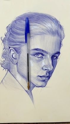 a drawing of a woman's face with a blue pen on top of it