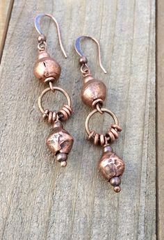 Bohemian style copper dangle earrings with Ethiopian copper.Rustic, handcrafted, fair-trade Ethiopian copper beads make these gorgeous earrings truly unique. Light-weight and versatile, copper pairs perfectly with other metal accessories and compliments a variety of wardrobe styles. A great everyday pair of earrings that enhance your favorite outfit.Product overview:* Made with handcrafted Ethiopian copper and copper plated ear wires* Light-weight and versatile, looks great copper or other metal Bohemian Brass Earrings In Rust Color, Rust Copper Dangle Earrings, Bohemian Rust Brass Earrings, Artisan Bronze Copper Earrings, Rust Copper Dangle Jewelry, Rust Colored Copper Dangle Jewelry, Rust-colored Copper Dangle Jewelry, Bohemian Rose Gold Copper Jewelry, Rust Colored Bohemian Metal Jewelry