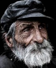 an old man with a long beard wearing a hat