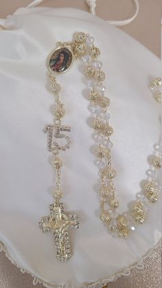 Looking for something extraordinary for that upcoming special occasion? This is a beautiful and elegant rosary made with high quality crystals. This gorgeous rosary is perfect for any occasion. It is absolutely unique and gorgeous from every angle. This gorgeous rosary features a beautiful elegant design. This is perfect for a First Communion, Confirmation, Christening, Quinceanera, or wedding for that special day! All items are custom made to order. Our turn around time is about 5-10 business d Quince Bible And Rosary, Necklaces For Quinceaneras, Themes For Quinceanera Decoration, Pink Quince Accessories, Quince Hair Down, Unique Quinceanera Themes, 15 Ideas Quinceanera, Gold Quinceanera Decorations, 15 Quinceanera Ideas