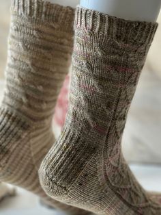 the legs of a person wearing brown socks