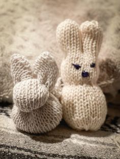 two knitted stuffed animals sitting next to each other