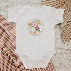 An adorable cottagecore baby bodysuit with trendy moths and flowers that sit on a lacy graphic.   Moth Bodysuit For Baby Boho Baby Clothes Cottagecore Baby Clothes Floral Moth Outfit for Infant Girl Baby Moth Shirt Fairycore Clothes Baby * Q U I C K * F A C T S * ✺ 100% ringspun cotton ✺ Light fabric ✺ plastic snaps closure  ✺ Inside out and wash and dry normally (on cool for best results). Do not iron decoration. ✺ printed using DTG Direct to Garment printing.  ✺ Colors may vary due to computer monitors and printing inks. ✺ While we offer several shirt colors some may have a better contrast with the design. Keep that in mind when choosing your color.  * S I Z I N G * ✺ Sizing is unisex  ✺ Size guide and fit: Please see size charts in photos for guidance on sizing to ensure the best fit. Spring Cotton Bodysuit With Floral Print, Spring Floral Print Cotton Bodysuit, Fitted Cotton Bodysuit For Baptism, White Onesie For Baptism In Summer, White Summer Onesie For Baptism, Spring Baptism Cotton Onesie, White Onesie For Baptism In Spring, Fitted White Onesie With Floral Print, Moth Outfit