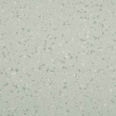 a white and green speckled wallpaper with lots of small dots on the surface