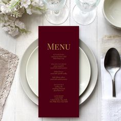 a table setting with place settings, silverware and napkins on top of it