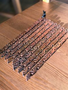 a wooden table topped with metal pieces on top of it