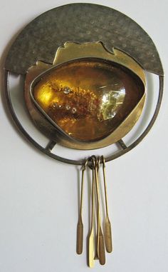 "This unusual sterling silver and gold fill amber pin is signed STERLING GOLD FILL AMBER CZ JOY. The circle measures 2\" and with the dangles measures approximately 3-1/4\". Has a secure holding roll over style pin back. Weighs 20.2 grams. Good condition but shows some cracking on the finish over the amber." Modernist Gold Brooch Jewelry, Modernist Gold Brooch, Modernist Gold Brooches For Gifts, Modern Gold Collectible Jewelry, Modern Gold Jewelry For Collectors, Amber Brooch Jewelry Gift, Mid-century Round Jewelry Gift, Modernist Handmade Gold Jewelry, Handmade Modernist Gold Jewelry