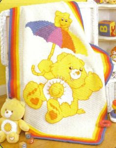 there is a crocheted blanket with teddy bears on it