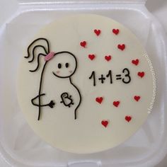 a white cake with red hearts on it in a plastic container that says 1 13