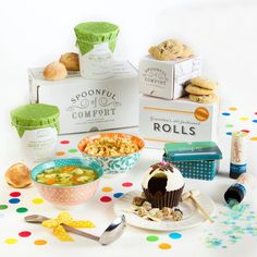 various foods and condiments are arranged on a table with polka dot paper around them