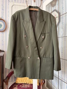 This jacket by Protocol is made from 65 per cent polyester and 35 per cent rayon in medium olive green. It is double breasted and has the original buttons in the front and on the cuffs, three front pockets and three inside pockets, and it's fully lined with silky dark green lining. Marked size 42. The measurements, taken with the jacket lying flat, ate: shoulder to shoulder, 21 inches; armpit to armpit, 23 inches; sleeves, 25 inches; length, 34 inches; bottom edge, 34 inches. In very good condit Semi-formal Sport Coat With Double-breasted Fastening, Semi-formal Double-breasted Sport Coat, Khaki Double-breasted Fall Blazer, Fall Double-breasted Khaki Blazer, Fall Khaki Double-breasted Blazer, Double-breasted Sport Coat With Double Button Closure, Green Double-breasted Outerwear With Pockets, Khaki Long Sleeve Blazer For Office, Khaki Winter Business Blazer