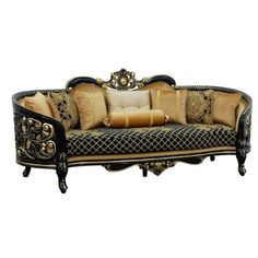 an ornately decorated couch with gold and black pillows on it's back end