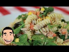 a white plate topped with pasta and veggies next to a smiling man's face