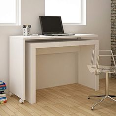 a laptop computer sitting on top of a white desk