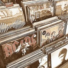 many framed records are stacked on top of each other with the word ac dc painted on them