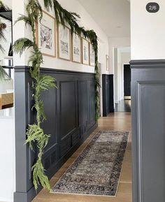 the hallway is decorated with greenery and framed pictures