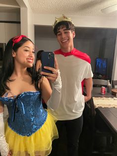 a man taking a selfie with a woman dressed as snow white and prince charming