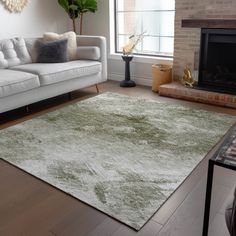 a living room filled with furniture and a large rug on top of a hard wood floor