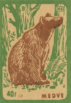 a stamp with a bear sitting in the woods