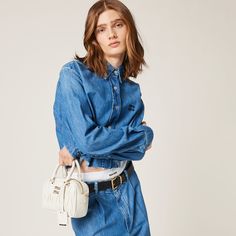 Washed denim Boxy fit Unlined Shirt collar Front button closure Long sleeves Buttoned cuffs Tonal top-stitching Embroidered logo Classic Miu Miu Cotton Tops, Classic Cotton Miu Miu Tops, Miu Miu Tops For Spring Workwear, Casual Miu Miu Tops For Spring, Miu Miu Long Sleeve Cotton Tops, Miu Miu Casual Tops For Workwear, Cropped Denim Top For Work, Chambray Shirt, Top Stitching