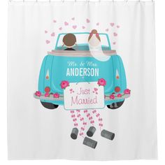 a shower curtain with a couple in the back of a blue car and hearts on it