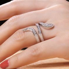 The snake is one of the oldest and most widespread mythological symbols, a symbol of transformation, rebirth and immortality. Crafted in sterling silver, the ring is set with glittering white stones as skin and decorated with smaller stones to add its spark. If you are interested in snake jewelry, just add this ring to your jewelrybox.Carat Weight: 1.471 ctStone Size: 1.9,1.7,1.5,1.3 mmStone Type: Jeulia® StoneNumber of Stones: 42 Stone Color: Diamond WhiteStone Shape: RoundWeight: 6 gWidth: 2.6 Elegant Silver Open Snake Ring, Elegant White Gold Snake-shaped Rings, Elegant White Gold Snake Shaped Rings, Snake-shaped Diamond Accented Jewelry For Anniversary, Snake Shaped Jewelry With Diamond Accents For Anniversary, Elegant Silver Snake Ring, Elegant Silver Snake Ring For Wedding, Elegant Snake-shaped Diamond Ring, Luxury White Gold Sterling Silver Snake Ring