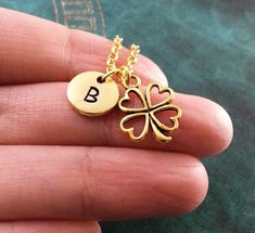 This listing is for a personalized four leaf clover necklace with a hand-stamped initial charm. You'll be able to choose your initial from the drop-down menu, as well as chain length and style. Keyrings are also available, just choose that as your option from the drop-down menu. :) **Please see the second photo for scale! This is a VERY SMALL charm. This necklace is made of gold-colored pewter and is hung by a gold-colored brass chain. The initial charm measures 3/8 inch. **Please note that this Dainty Personalized Good Luck Charm Necklaces, Personalized Round Good Luck Charm Necklaces, Personalized Round Charm Necklace For Good Luck, Personalized Initial Pendant Necklace For Good Luck, Personalized Good Luck Necklace For Mother's Day, Gold Jewelry For St. Patrick's Day Gift, Clover Keychain, Tree Keychain, Lucky Charm Necklace