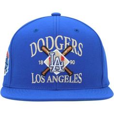 the los angeles dodgers baseball cap is blue and has two crossed bats on it,