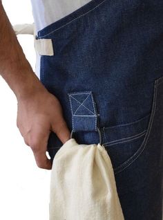 a man is holding his pocket open to show what he's doing with it