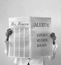 a person holding up a newspaper with the words alerita written on it in spanish