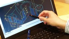 a person is using a pen to draw an object on a computer screen with blueprint