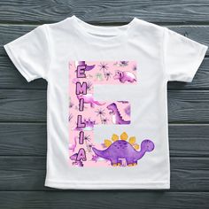 These cute Personalised t-shirts are perfect for every birthday celebration. Our t shirts are not just a great party outfit, but they also make great gifts and keepsakes. These Lovely dinosaur sets come with 12 different dinosaur designs,  The colouring for the name is in keeping with the colour scheme of the design unless you add a note to choose a different colour. Names are also able to be add to give the t shirts the personalised touch, please just add them in the personalisation box. There are lots of other themes available so please check out my shop, if you can't find what you are looking for please don't hesitate to send a message and let me work my magic.  Please Note *Please ensure if you are adding a name that it is spelt correctly, as these mistakes cannot be rectified, but of Playful Personalized T-shirt As Gift, Personalized Playful T-shirt As Gift, Playful Personalized T-shirt For Gift, Family Matching White Dinosaur Print T-shirt, White Dinosaur Print T-shirt For Family Matching, White T-shirt With Dinosaur Print For Birthday, Crew Neck T-shirt With Dinosaur Print For First Birthday, Green T-shirt With Dinosaur Print For Birthday, First Birthday T-shirt With Dinosaur Print