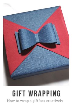 a blue and red box with a bow tie on it's side that says, gift wrapping how to wrap a gift box creativityly