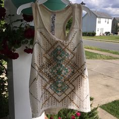 Tan Tank With Gold/Silver/Turquoise Pattern Lace Embellishment. Bohemian Cream Cotton Top, Cream Cotton Tops For Festival, Cream Summer Top For Festival, Cream Summer Tops For Festival, Cream Summer Festival Top, Bohemian Beige Tank Top, Fitted Turquoise Bohemian Tops, Cream Bohemian Tops For Summer, Fitted Bohemian Turquoise Tops