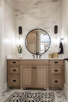 a bathroom vanity with a round mirror above it