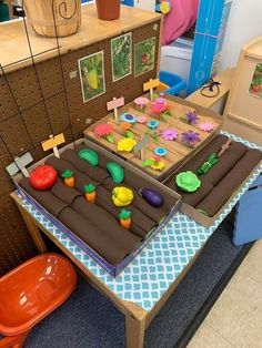 a table that has some toys on top of it in a room with other items