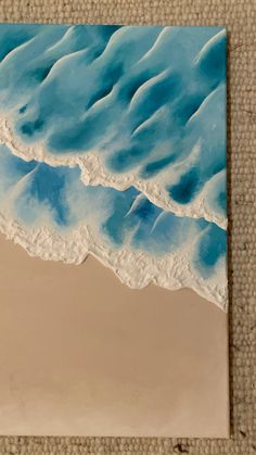 a painting of waves on the sand and water