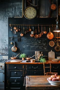 an old fashioned kitchen with pots and pans hanging on the blackboard behind it