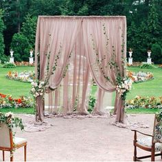 an outdoor ceremony setup with flowers and greenery