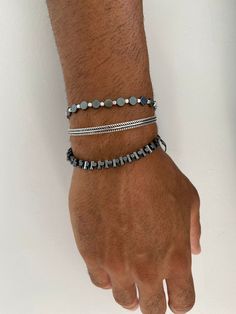 Three different handmade bracelets that are made from hematite and metal beads. A unique round beaded bracelet, a silver bangle that is made from sterling silver 925 and the last bracelet has bar beads that are passed through a black cord. You can wear them together or separetely as well. In Christina Christi Jewels store you can see more than 100 designs in Men's Bracelets. You can have them in 2-4 Days with DHL EXPRESS SHIPPING MATERIALS - Hematite Beads. - Metal Beads. - Round Beads are passe Adjustable Gunmetal Metal Bracelets, Adjustable Gunmetal Metal Bracelet, Stackable Metal Bracelets With Round Beads, Modern Metal Beaded Bangle Bracelets, Adjustable Gunmetal Bracelet, Stackable Metal Beaded Bracelets With Round Beads, Stackable Beaded Bracelets With Round Metal Beads, Stackable Metal Beaded Bracelets, Modern Hematite Bracelets As A Gift