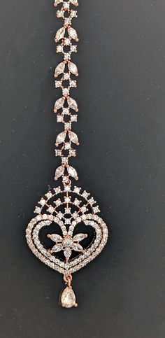 Whether you're the bride or a bridesmaid, adding a beautiful Small and Slim Rose Gold-Plated AD-Studded to your lehenga is always a great idea! This stunning American Diamond maang tikka is designed to steal the show with its elegant charm. The incredible craftsmanship makes it a real treat for jewelry lovers like us! American Diamond Studded Beautiful Rose Gold-Plated Maang Tikka/ Party wear Maag Tikka/ Hair Jewelry/Matha patti/ Indian forehead jewelry/ Small and Slim Rose gold Maang Tikka /Ros Adjustable Tikka For Wedding, Elegant Party Tikka With Hand Set Details, Elegant Hand Set Bridal Accessories For Celebration, Rose Gold Bridal Necklace For Party, Elegant Adjustable Tikka For Festive Occasions, Elegant Adjustable Tikka As Gift, Adjustable Elegant Tikka As Gift, Traditional Wedding Jewelry Headband, Adjustable Elegant Tikka Gift