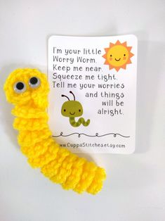 a yellow caterpillar with eyes on it's side next to a card that says, i'm your little worry worm keep me near squeeze me tight tell me